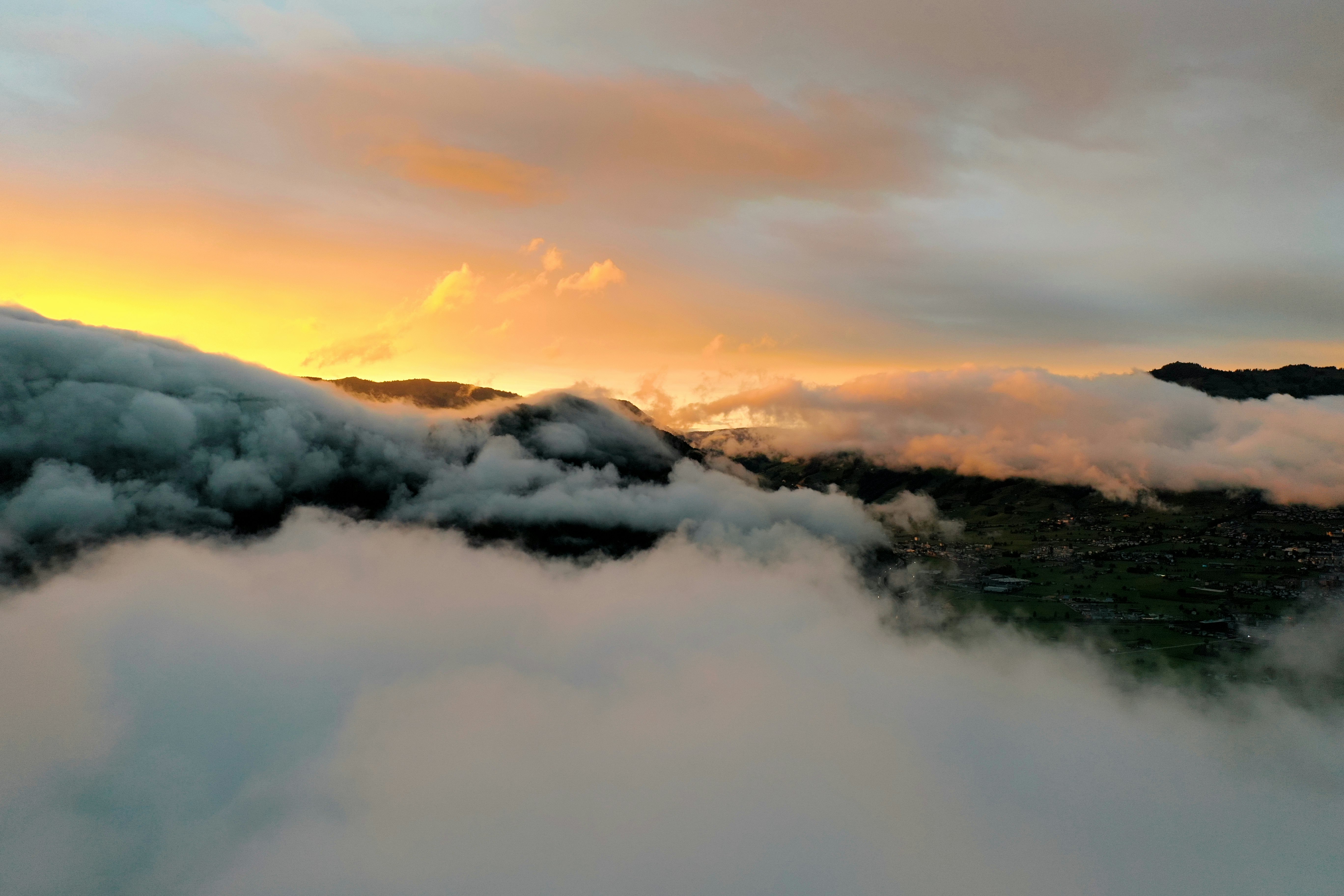 white clouds over mountains during daytime